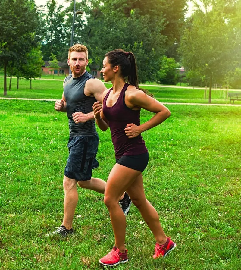 Couple running through a park