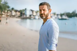 Man posing for the camera on a beach