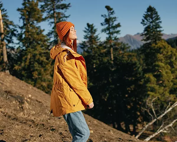 Woman breathing fresh air in the forest - Aging Optimized